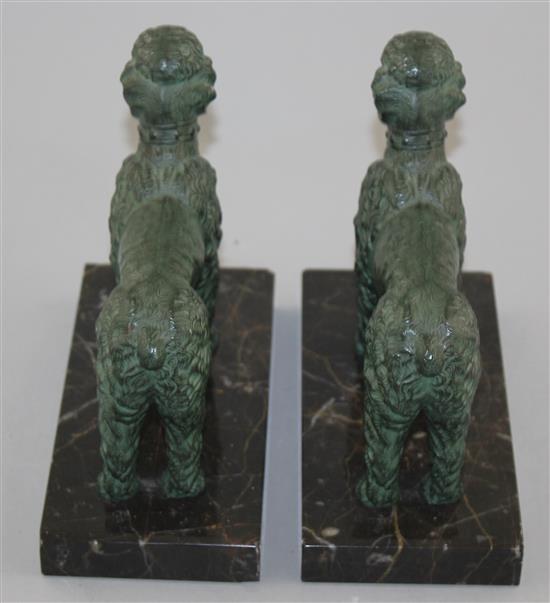 A pair of French Art Deco patinated metal bookends, modelled as poodles, 6in.